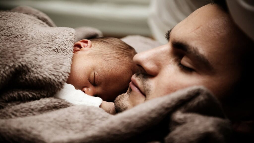 Hombre durmiendo con bebé
